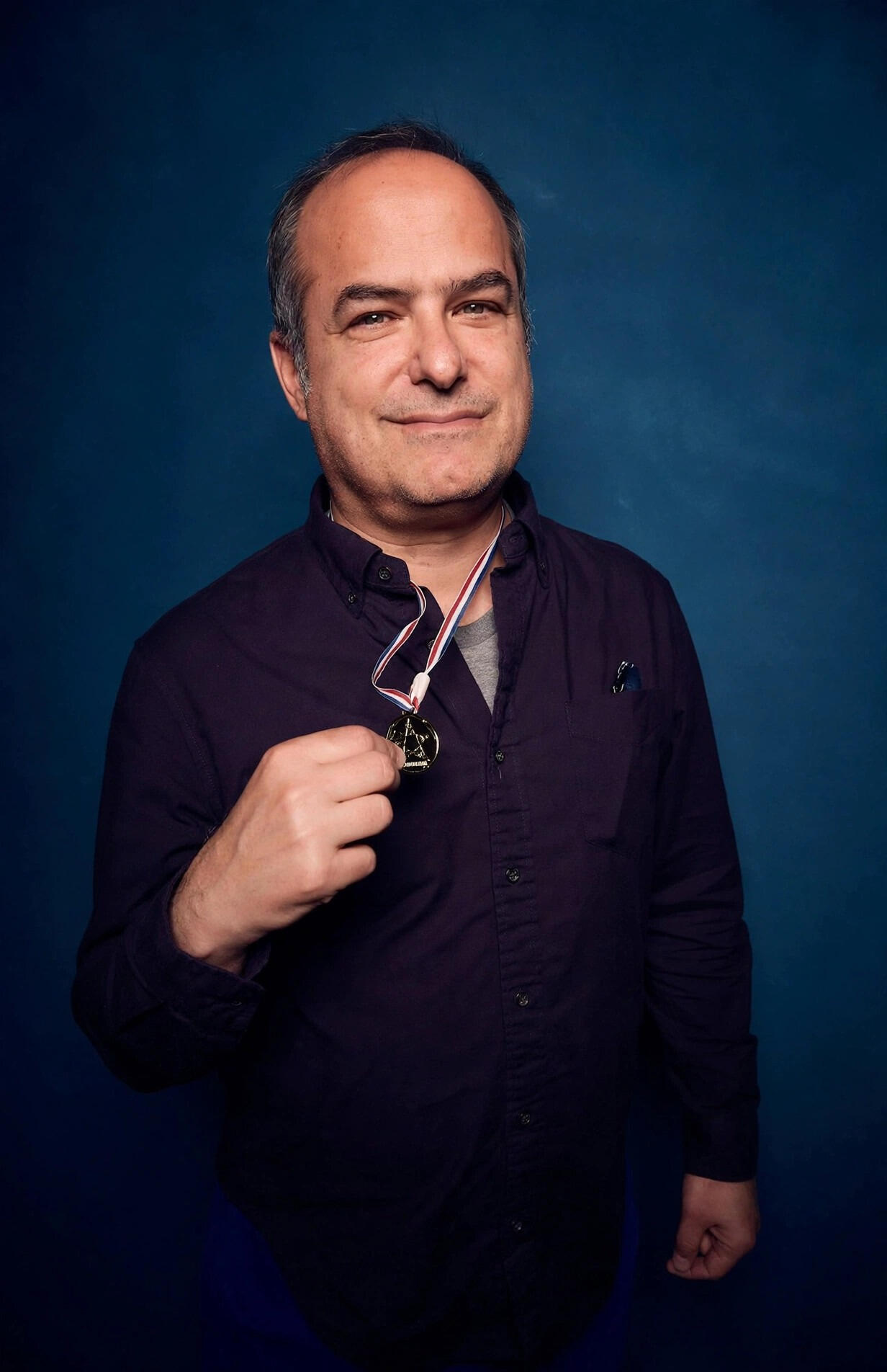 Neal Pollack holding his Jeopardy! medal